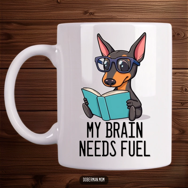 Funny Doberman Mug showing a smart Doberman dog wearing reading glasses, intently reading a book with a smile.