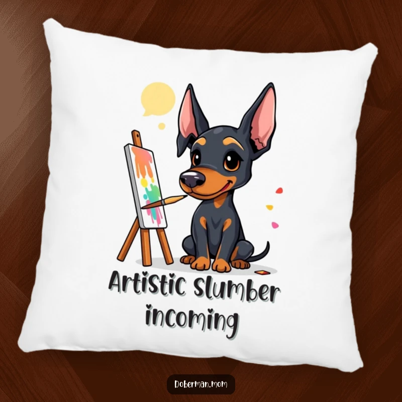 Funny Doberman artist pillow showing a dog artist with a paintbrush, creating a colorful and expressive masterpiece.
