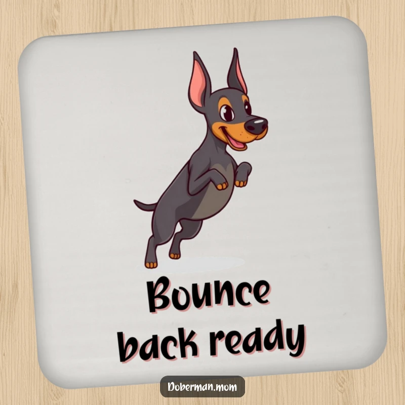 Funny Determined Doberman coaster featuring focused practice of a tiny jump, adding athletic humor and protecting surfaces.