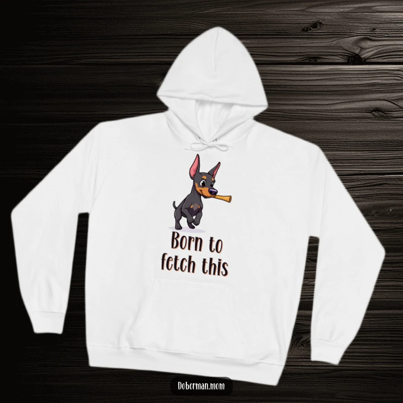 Funny Doberman with a determined gaze, ready to retrieve a stick, showcased on this powerful hoodie.