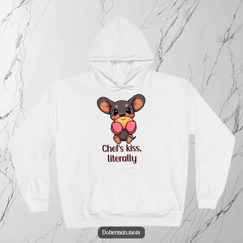 Funny Doberman dog in oven mitts, holding a warm pastry, featured on a cozy hoodie, ideal for baking enthusiasts.