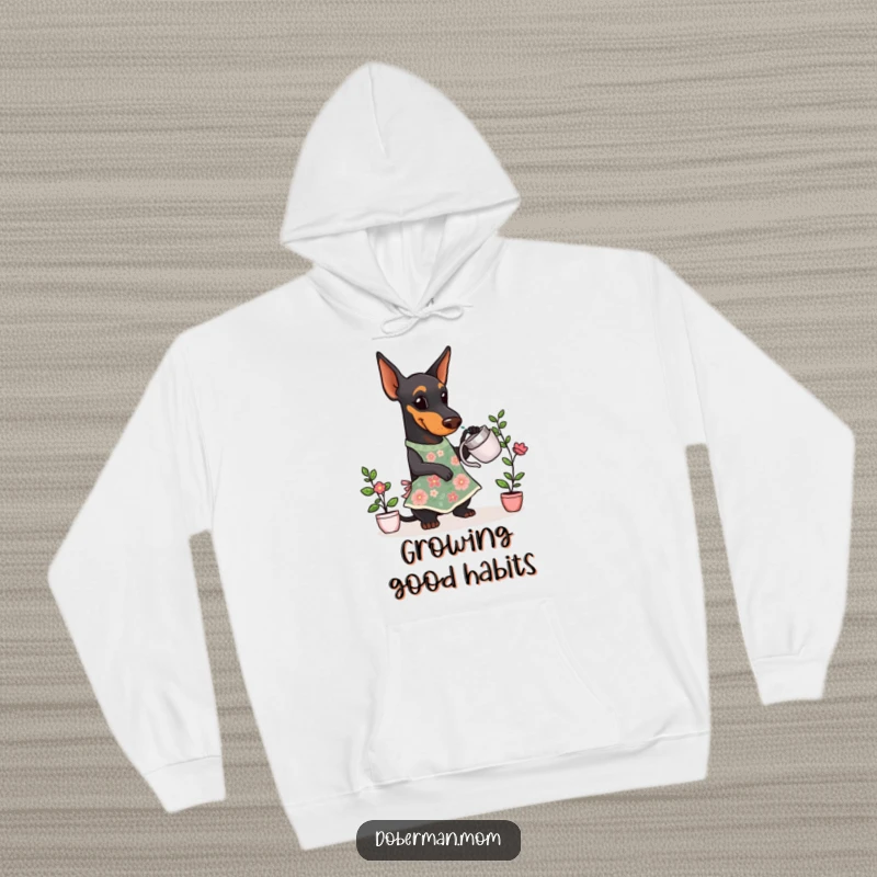 Funny Doberman Gardener Hoodie showing a Doberman dog in a cute floral apron, watering a tiny plant with care.