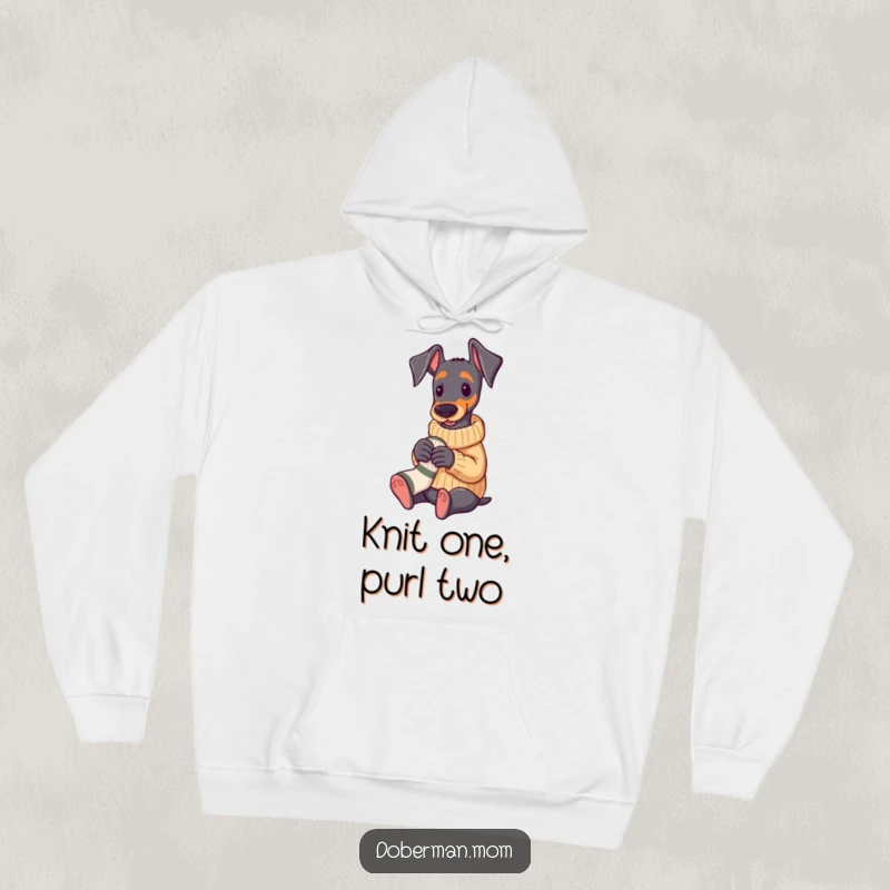 Funny Doberman in a cozy sweater knitting a tiny sock, warm and humorous hoodie.