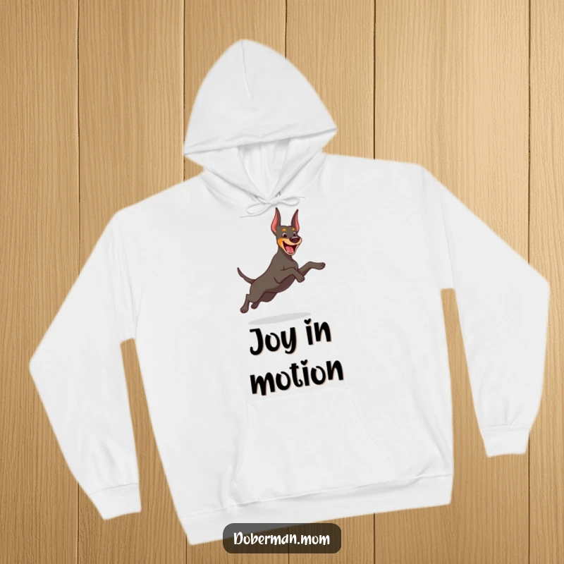 Funny Doberman hoodie showcasing a cheerful dog captured mid-playful, graceful leap, radiating energy and happiness.