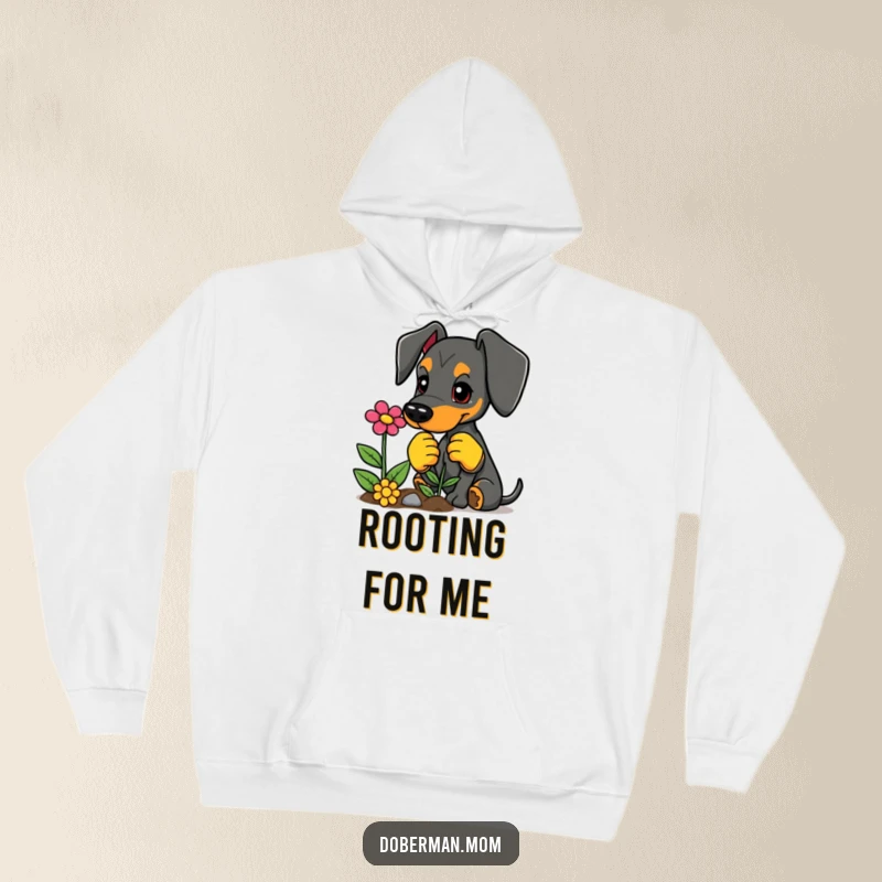 Funny Doberman hoodie, dressed in gardening gloves, planting a vibrant flower, cozy and humorous.