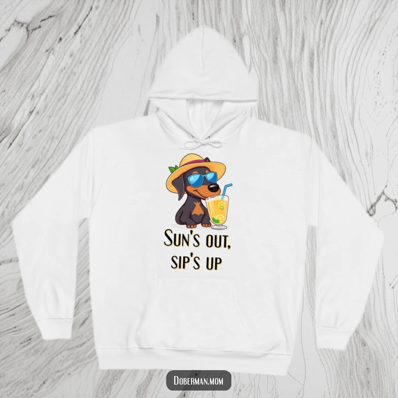 Funny Doberman dog wearing a sun hat and sipping a drink, a cozy and humorous hoodie.