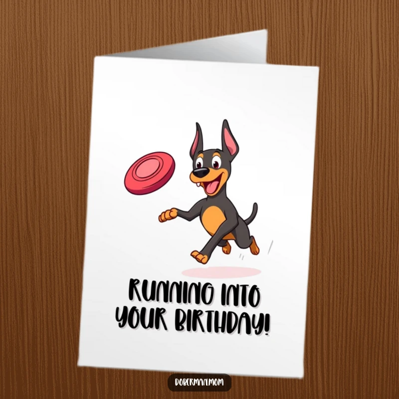 Funny Free Printable Birthday Card: A Doberman joyfully running and leaping with a frisbee, celebrating a birthday with playful energy.