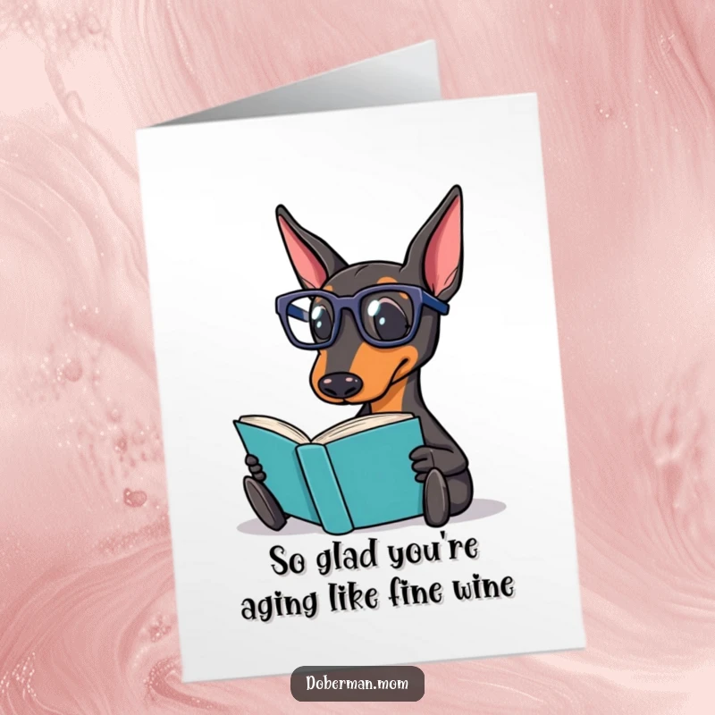 Funny Free Printable Birthday Card: Doberman wearing reading glasses intently reading a book, symbolizing intelligence and relaxation.