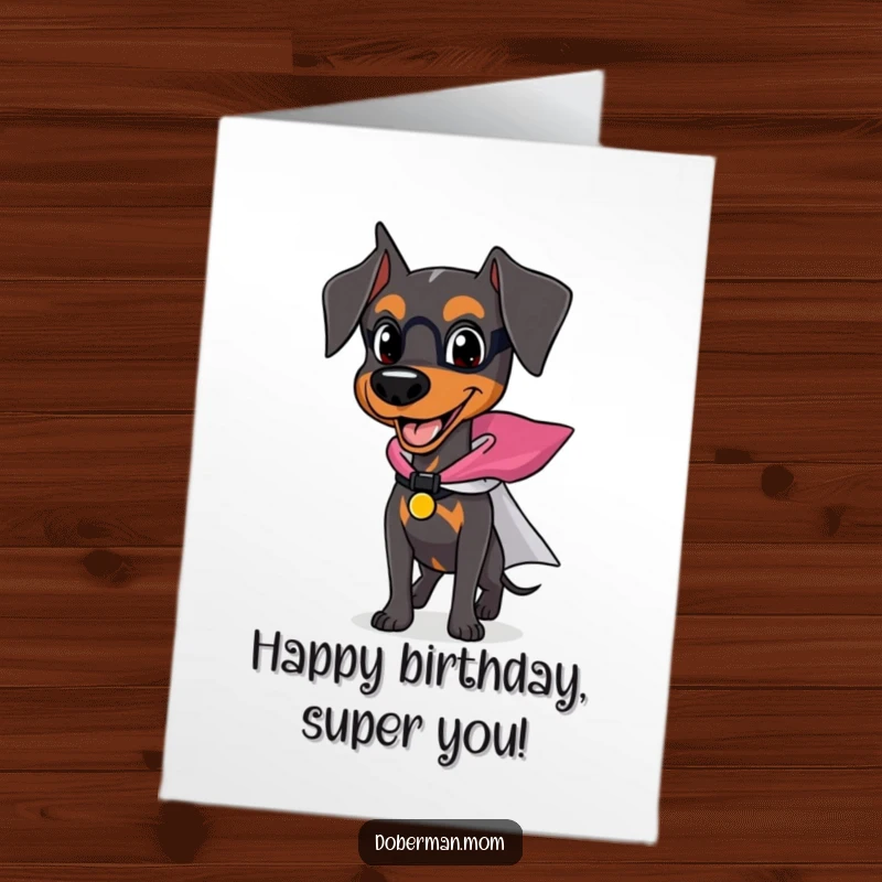 Funny Free Printable Birthday Card featuring a happy Doberman dog wearing a tiny superhero cape, poised for action and birthday adventures.
