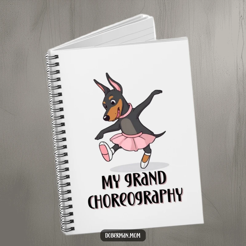 Funny Doberman dog in ballet slippers, attempting a pose, on a notebook cover, ideal for jotting down dance moves humorously.