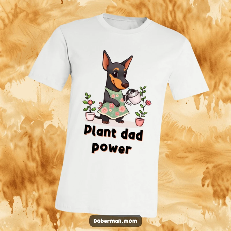 Funny Doberman Gardener T-Shirt featuring a Doberman dog dressed in a floral apron, gently watering a small potted plant.