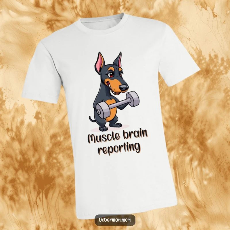 Funny Doberman t-shirt with a determined dog balancing a small dumbbell, perfect for gym enthusiasts and dog lovers.