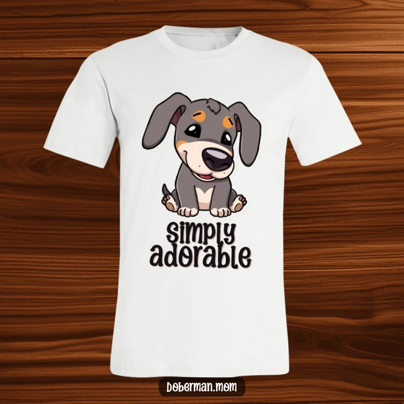 Funny T-Shirt: Kawaii Doberman character with cute features, playfully bowing its head, embodying sweet charm.