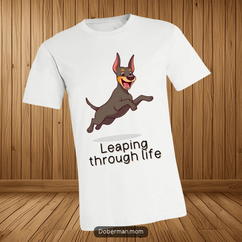 Funny Doberman t-shirt with a cheerful dog caught in a graceful, energetic, playful leap, embodying pure joy.