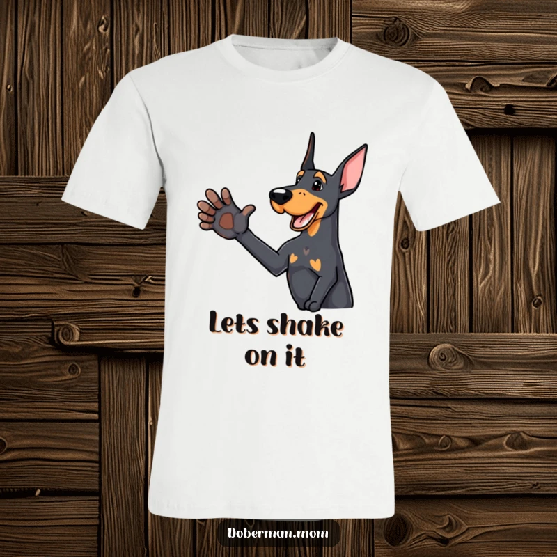 Funny Doberman t-shirt with a delighted dog offering an outstretched paw for a friendly handshake, promoting connection.
