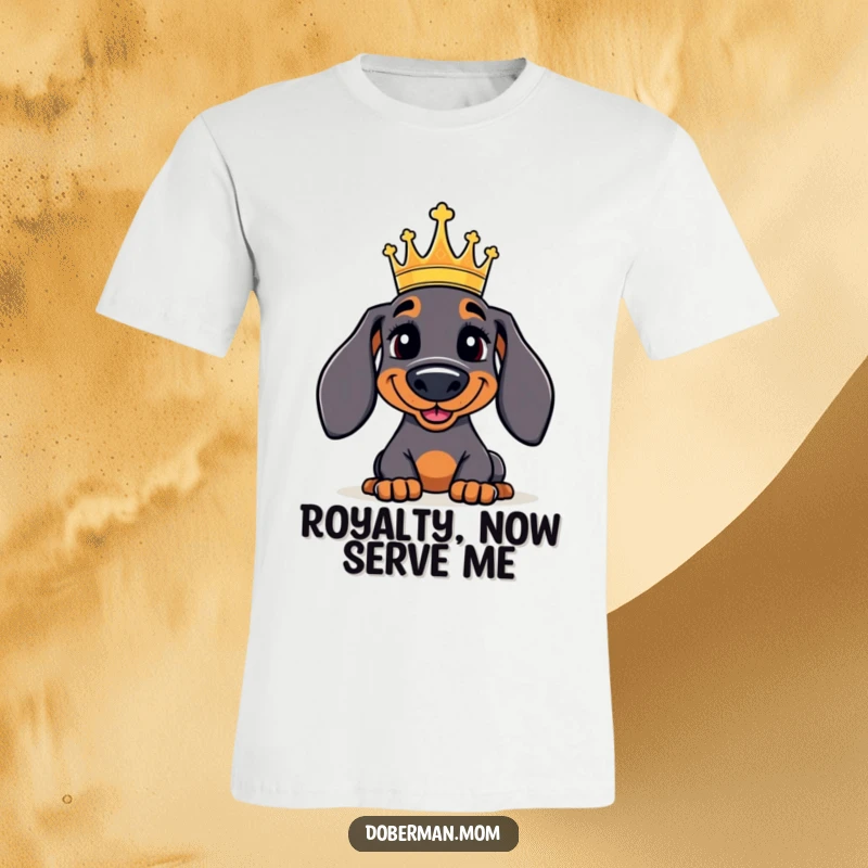 Funny Doberman T-Shirt: A jolly Doberman dog proudly wearing a miniature crown, exuding a regal and humorous aura.