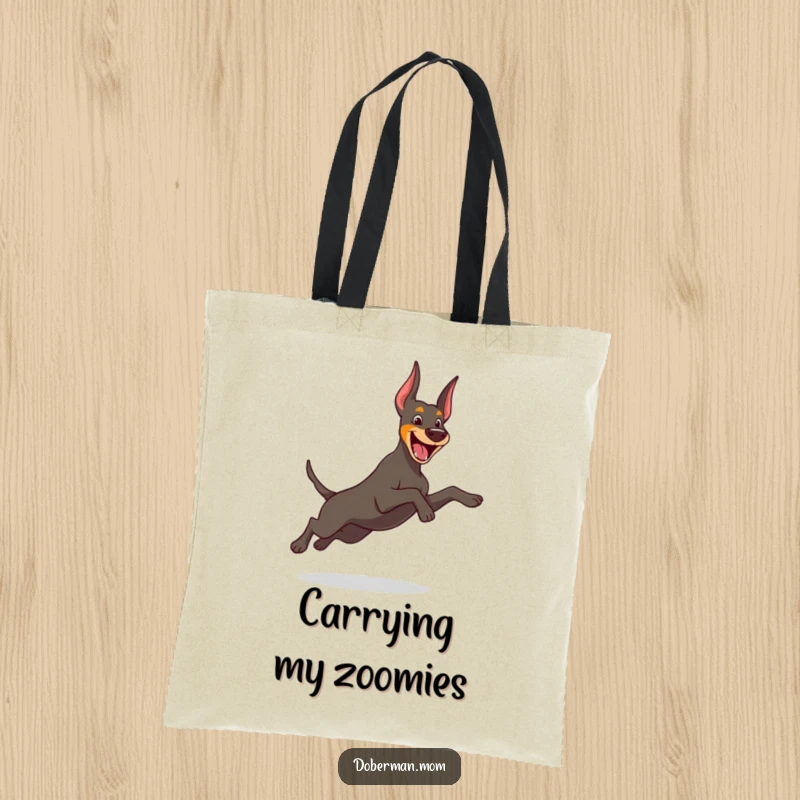 Funny Doberman tote bag featuring a cheerful dog performing a graceful, playful leap, perfect for carrying essentials with joy.