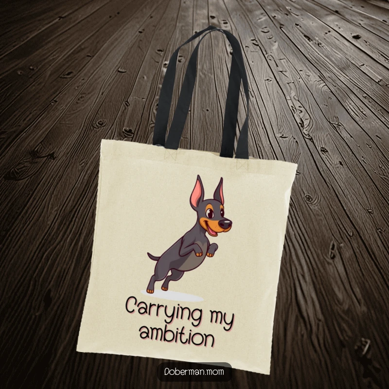 Funny Determined Doberman tote bag showing focused practice of a tiny jump, ideal for carrying gym gear or daily items with athletic humor.