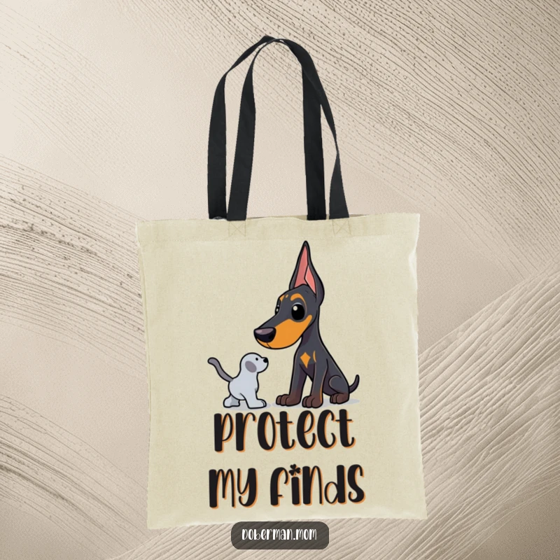 Funny Doberman tote bag featuring a dog in a protective stance, watching over a favorite toy with humorous devotion.